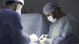 Details of a real surgery in the sterile operating theatre. Action. Medical background of doctors